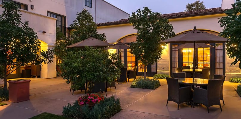 Outdoor seating area with tables and umbrellas