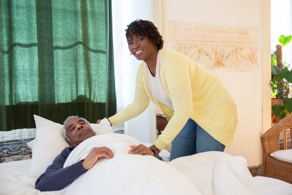 A caregiver assisting a resident in a bright room