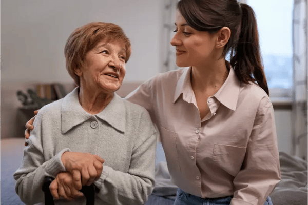 Caregiver interacting with a resident in a cozy room