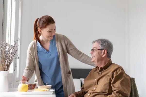 Staff member serving a meal to a resident