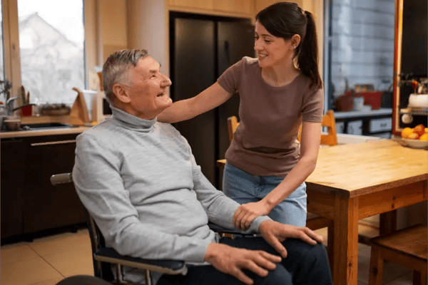 Staff interacting with a resident in a cozy kitchen