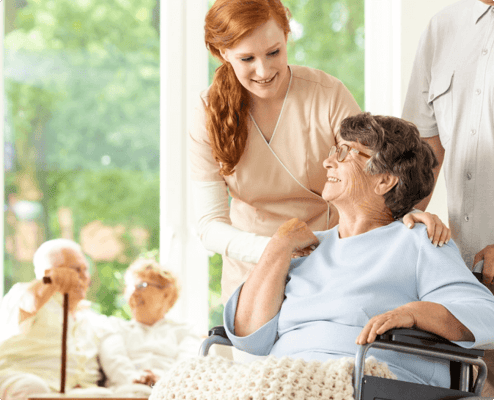 A caregiver interacting with a resident in a bright room