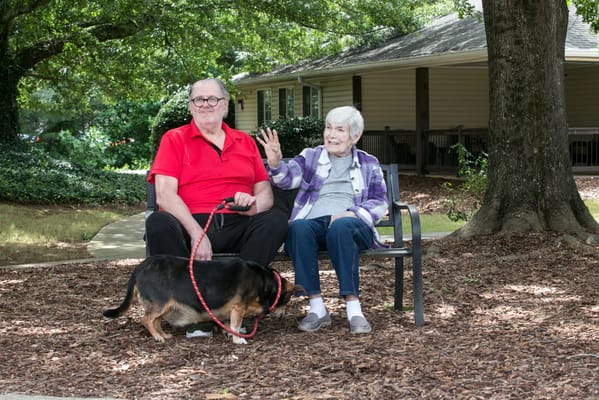Residents enjoying the outdoors with a dog