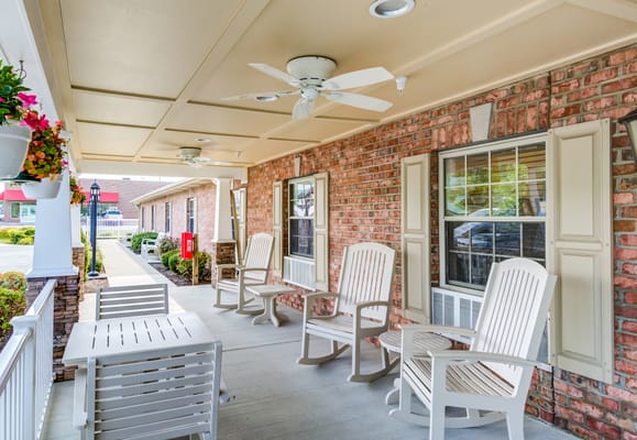 Outdoor seating area with white chairs on a patio