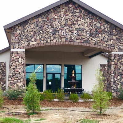 Front entrance of a senior living facility with landscaping