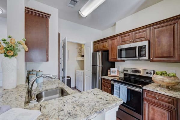 Modern kitchen with granite countertops and appliances