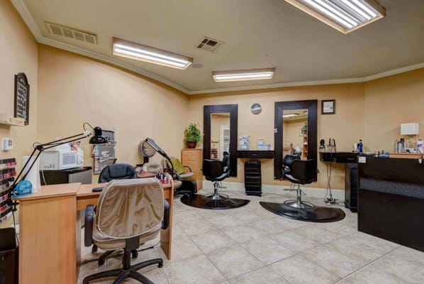 Hair salon area with styling chairs and workstations