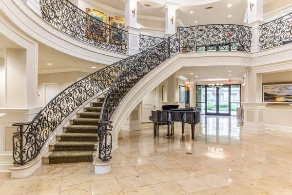 Elegant lobby with a grand staircase and piano
