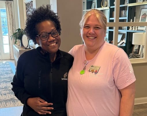 Staff member and resident smiling in a common area