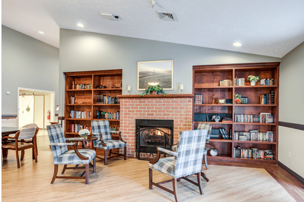 Cozy common area with comfortable seating and bookshelves