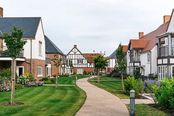Walkway surrounded by buildings in a landscaped area