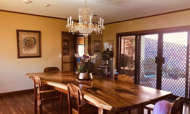 Dining area with a large wooden table and chandelier