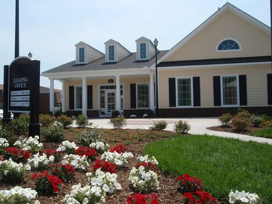 Exterior view of the leasing office with flowers in the foreground
