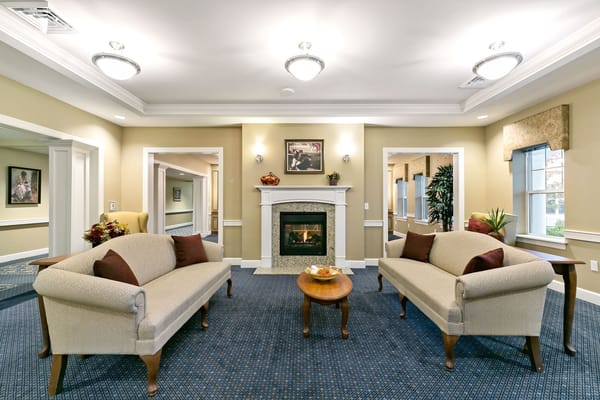 Bright common area with cozy seating and a fireplace