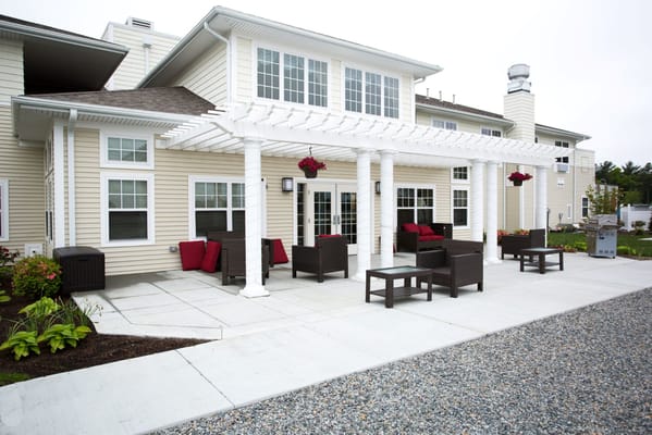 Outdoor seating area with a pergola and landscaping