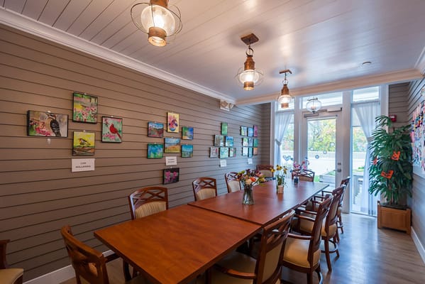Bright common area with artwork and a large table
