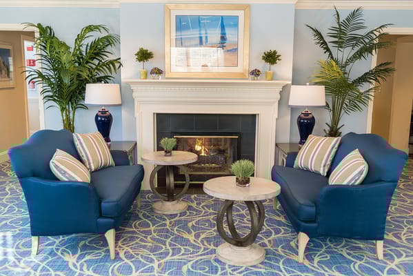 Cozy seating area with a fireplace and decorative plants