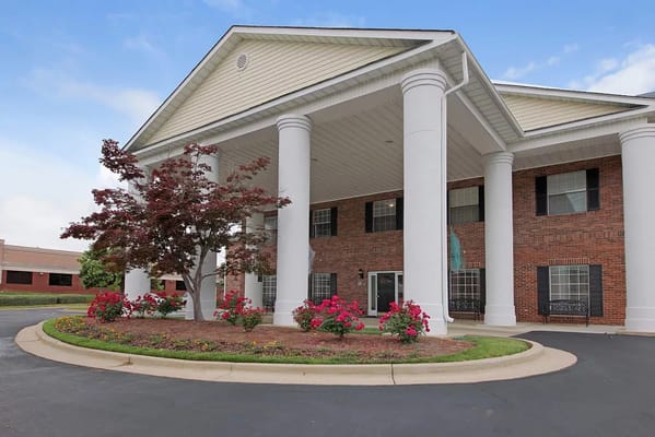 Exterior view of a senior living facility with landscaping