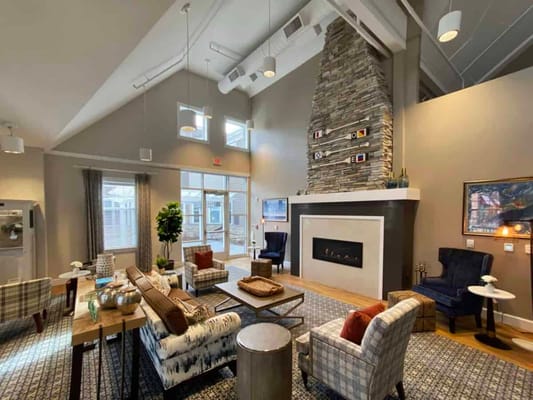 Bright common area with seating and fireplace