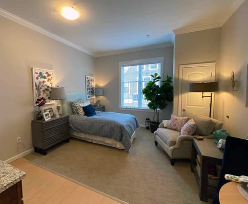 Cozy private resident room with a bed and seating area