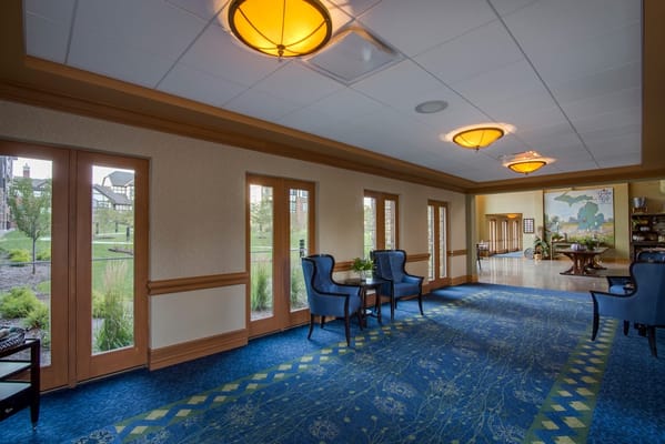 Bright interior common area with seating and large windows