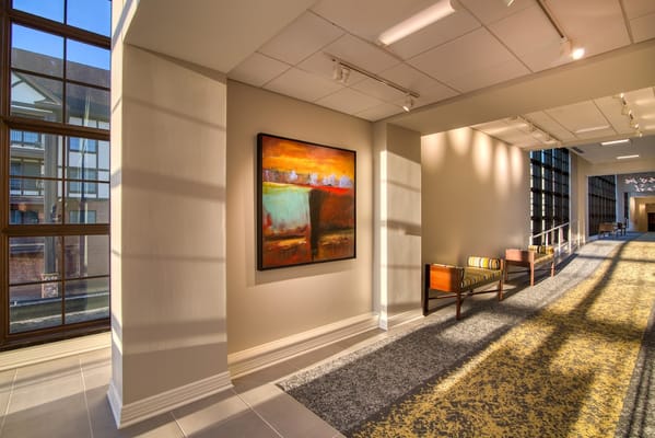 Bright interior hallway with artwork and seating