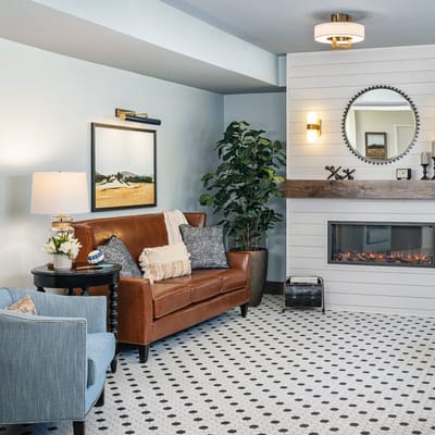 Cozy lounge area with a fireplace and artwork