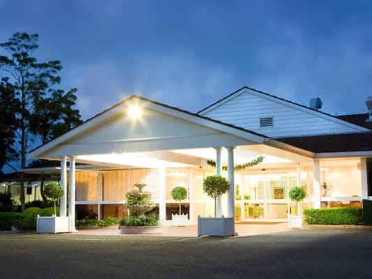 Exterior view of the facility entrance at dusk