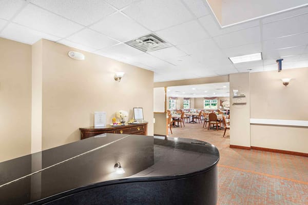 Interior view of a common area with seating and piano