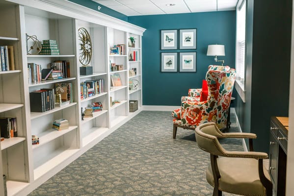 A cozy common area with bookshelves and seating