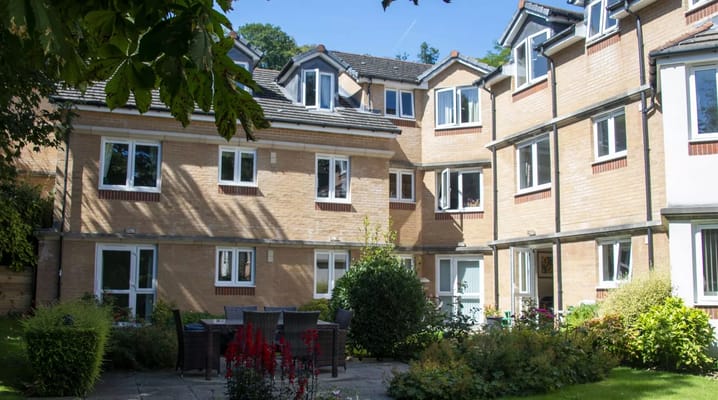 A sunny courtyard with seating and landscaped garden