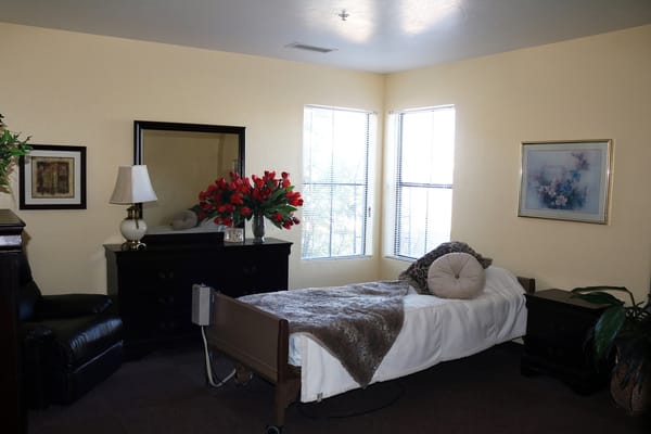 Well-furnished resident room with a bed and decor