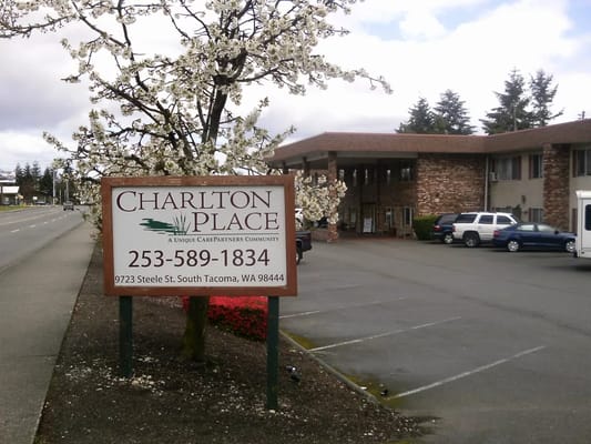 Exterior view of Charlton Place senior living facility with trees