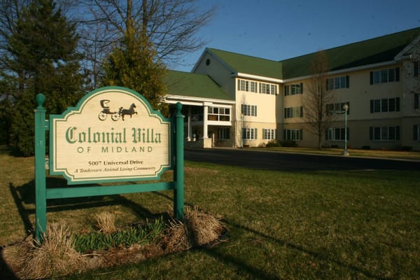 Exterior view of Colonial Villa building and sign