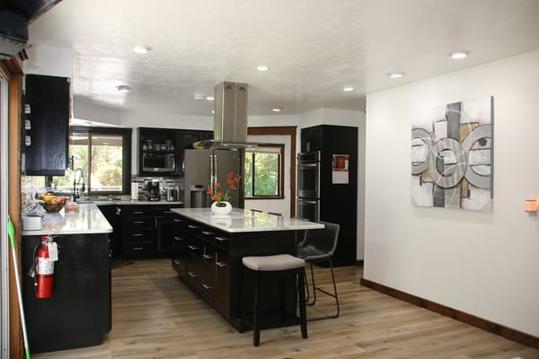 Bright and modern kitchen with black cabinetry and a central island
