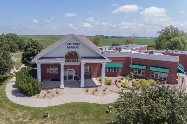 Aerial view of Colonial Manor building with gardens