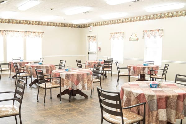 Interior dining area with tables set for residents