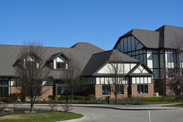 Exterior view of a senior living facility with landscaped grounds