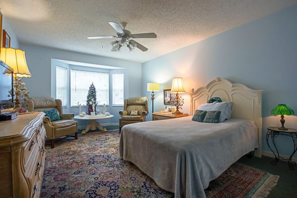 Brightly decorated bedroom with a bed and seating area