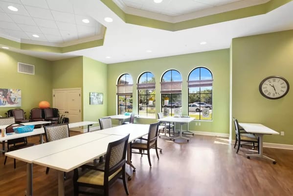 Interior common area with tables and green walls