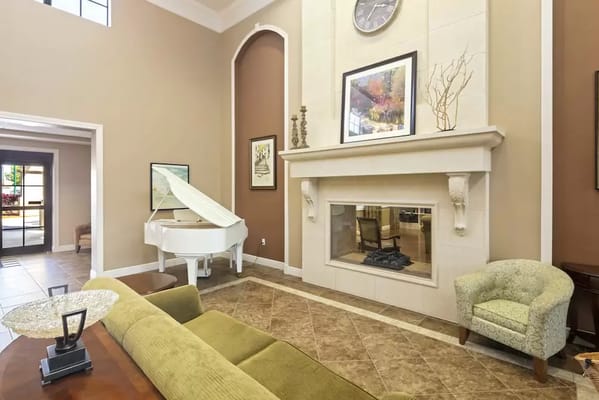 Bright interior common area with a piano and seating