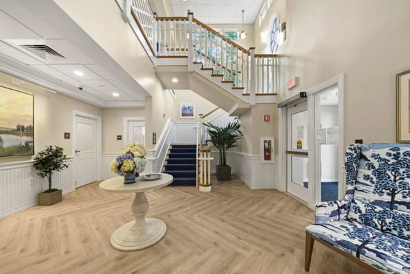 Bright interior lobby with staircase and decor