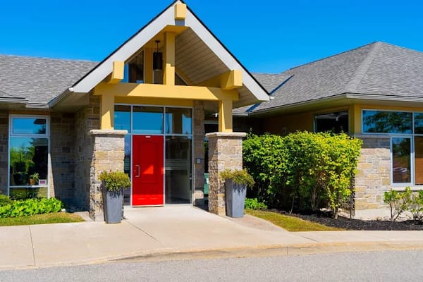 Exterior view of a nursing home entrance with red door