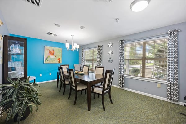Modern dining room with a large table and blue accent wall