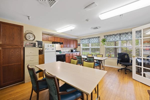 Bright kitchen and dining area with tables and chairs at Granville Place.