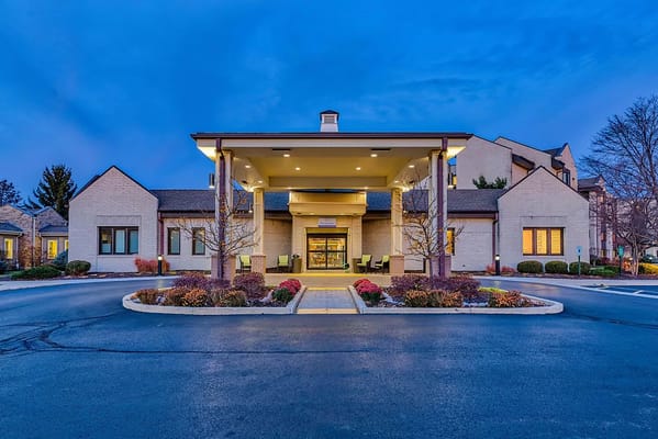 Facade of Harbour Village at dusk with landscaped entry