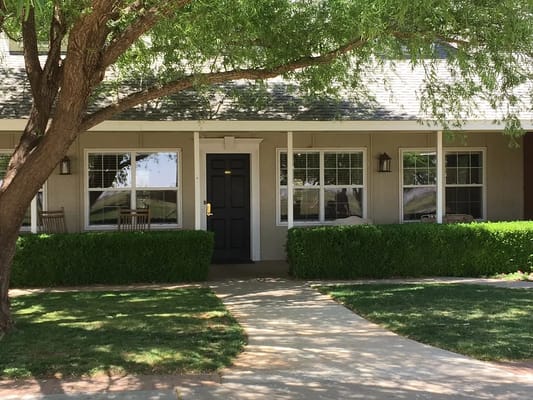 Building exterior with a pathway and greenery