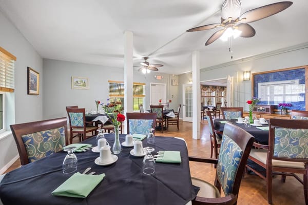 Elegant dining setup with tables and floral arrangements