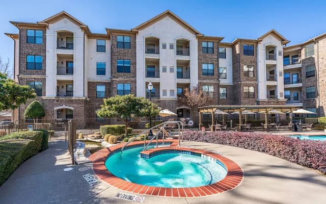 Exterior view of a senior living facility with pool area