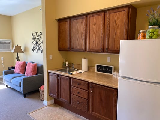 Cozy interior of a resident's living space with a kitchenette